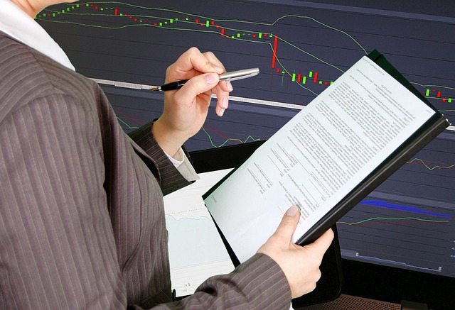 An image showcasing a close-up of a hand holding a stack of money, surrounded by charts and graphs displaying profitable trades