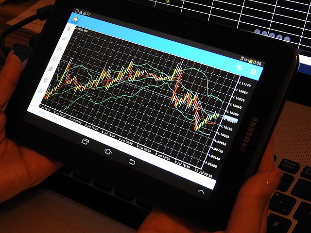 An image showing a stock market graph, with rising green bars indicating profit, while a magnifying glass hovers over the graph, symbolizing the importance of analyzing market trends and data for lucrative forex trading