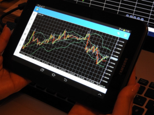 An image showcasing the secrets of forex trading, with a close-up view of a QFX trading platform